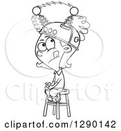 Cartoon Clipart Of A Black And White Girl Sitting On A Stool With A Thinking Cap On Royalty Free Vector Line Art Illustration by toonaday