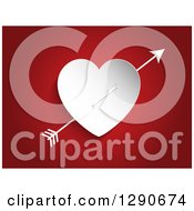 Poster, Art Print Of Cupids Arrow Through A White Paper Heart On Red