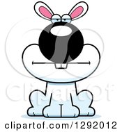 Clipart Of A Cartoon Bored White Rabbit Sitting Royalty Free Vector Illustration