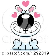 Clipart Of A Cartoon Loving White Rabbit Sitting With Hearts Royalty Free Vector Illustration