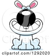 Clipart Of A Cartoon Happy Grinning White Rabbit Sitting Royalty Free Vector Illustration