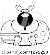 Holiday Clipart Of A Black And White Cartoon Surprised Gasping Easter Bunny With Eggs Royalty Free Lineart Vector Illustration
