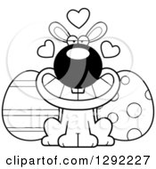 Holiday Clipart Of A Black And White Cartoon Loving Easter Bunny With Eggs And Love Hearts Royalty Free Lineart Vector Illustration