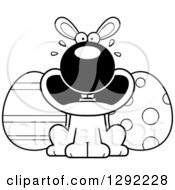 Holiday Clipart Of A Black And White Cartoon Scared Screaming Easter Bunny With Eggs Royalty Free Lineart Vector Illustration