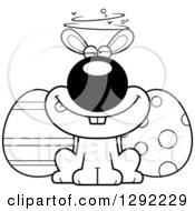 Holiday Clipart Of A Black And White Cartoon Drunk Or Dizzy Easter Bunny With Eggs Royalty Free Lineart Vector Illustration