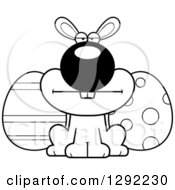 Holiday Clipart Of A Black And White Cartoon Mad Easter Bunny With Eggs Royalty Free Lineart Vector Illustration