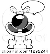 Animal Clipart Of A Black And White Cartoon Happy Talking Rabbit Sitting Royalty Free Lineart Vector Illustration