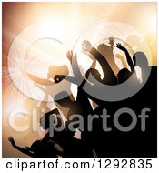 Clipart Of A Group Of Young Silhouetted Dancers Against Bright Lights And Orange Flares Royalty Free Vector Illustration