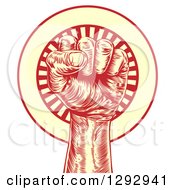Poster, Art Print Of Retro Red And Yellow Engraved Revolutionary Fist Over A Circle Of Rays