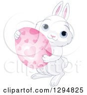 Poster, Art Print Of Cute White Bunny Holding A Pink Heart Patterned Easter Egg