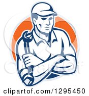 Clipart Of A Retro Male Mechanic With Folded Arms Holding A Wrench In A Gray And Orange Circle Royalty Free Vector Illustration