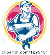 Clipart Of A Retro Male Mechanic Rolling Up His Sleeves And Holding A Wrench In A Yellow White And Pink Circle Royalty Free Vector Illustration