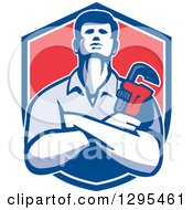 Clipart Of A Retro Male Plumber With Folded Arms Holding A Monkey Wrench In A Blue White And Red Shield Royalty Free Vector Illustration