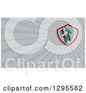 Clipart Of A Retro Rugby Player And Gray Rays Background Or Business Card Design Royalty Free Illustration