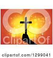 Clipart Of A Silhouetted Hand Holding Up A Cross With Glowing Orange Lights Royalty Free Vector Illustration by ColorMagic