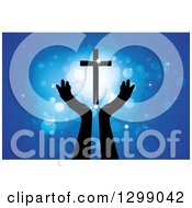 Clipart Of Silhouetted Hands Under A Floating Cross With Glowing Blue Lights Royalty Free Vector Illustration