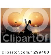 Clipart Of A Silhouetted Easter Bunny With Eggs Butterflies And Grass Against A Magical Orange Sunset Royalty Free Vector Illustration
