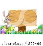 Poster, Art Print Of Brown Easter Bunny Rabbit With Eggs Pointing To A Blank Wood Sign