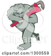 Clipart Of A Cartoon Roaring Angry Grizzly Bear Plumber Mascot Carrying A Giant Monkey Wrench Royalty Free Vector Illustration