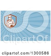 Clipart Of A Retro Male Mechanic With Folded Arms And A Wrench And Blue Rays Background Or Business Card Design Royalty Free Illustration