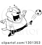 Cartoon Black And White Chubby Badger Kicking A Soccer Ball