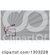 Poster, Art Print Of Cartoon Hand Holding A Clapperboard And Gray Rays Background Or Business Card Design