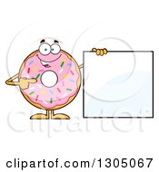 Cartoon Happy Round Pink Sprinkled Donut Character Pointing To A Blank Sign