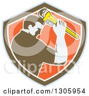 Clipart Of A Retro Male Plumber Bowing And Holding A Monkey Wrench To His Head In A Blue Brown White And Orange Shield Royalty Free Vector Illustration