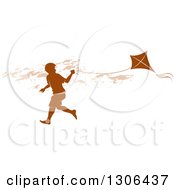 Clipart Of A Brown Silhouetted Boy Running With A Kite Royalty Free Vector Illustration by Lal Perera