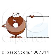 Cartoon Happy Round Chocolate Donut Character Holding And Pointing To A Blank Sign