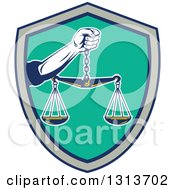 Clipart Of A Retro Hand Holding Scales Of Justice In A Black Gray And Turquoise Shield Royalty Free Vector Illustration