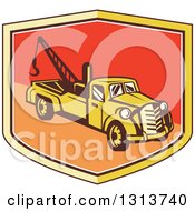 Retro Tow Truck In A Yellow Red And Orange Shield