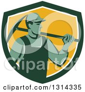 Retro Male Coal Miner Holding A Pickaxe In A Green White And Yellow Shield
