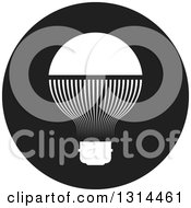 Clipart Of A White LED Light Bulb In A Round Black Icon Royalty Free Vector Illustration by Lal Perera