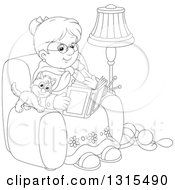Cartoon Black And White Granny Sitting In A Chair And Reading A Book With A Kitten And Yarn At Her Feet