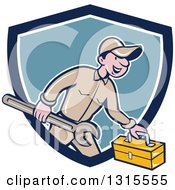 Retro Cartoon Happy White Male Mechanic Runnign With A Spanner Wrench And A Tool Box Emerging From A Blue And White Shield