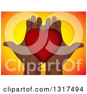 Poster, Art Print Of Pair Of Open Black Hands Holding A Red Love Heart Over Gradient Yellow And Orange