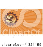 Clipart Of A Retro Welder Working In A Gear Frame And Orange Rays Background Or Business Card Design Royalty Free Illustration