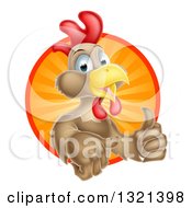 Poster, Art Print Of Happy Brown Chicken Or Rooster Mascot Giving A Thumb Up And Emerging From A Sun Ray Circle
