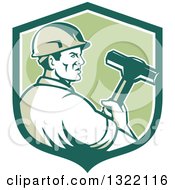 Retro Male Construction Worker Holding A Sledgehammer In A Green And White Shield