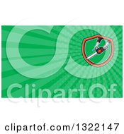 Clipart Of A Retro Mans Hands Holding A Chainsaw And Green Rays Background Or Business Card Design Royalty Free Illustration