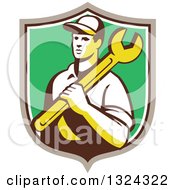 Poster, Art Print Of Retro Male Mechanic Holding A Wrench And Emerging From A Taupe White And Green Shield