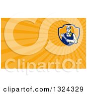 Clipart Of A Retro Male Mechanic Holding A Wrench And Orange Rays Background Or Business Card Design Royalty Free Illustration