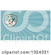 Clipart Of A Retro Male Mechanic Holding A Wrench And Blue Rays Background Or Business Card Design Royalty Free Illustration