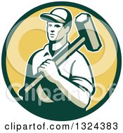 Retro Male Construction Worker Carrying A Sledgehammer In A Green And Yellow Circle