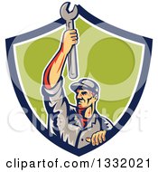 Poster, Art Print Of Retro Male Mechanic Holding A Wrench Above His Head In A Blue White And Green Shield