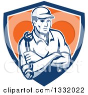 Poster, Art Print Of Retro Male Mechanic Holding A Wrench In Folded Arms In A Blue White And Orange Shield