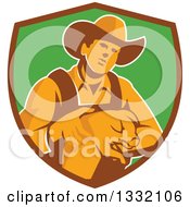 Poster, Art Print Of Retro Male Farmer Holding A Piglet In A Brown And Green Shield