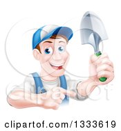 Clipart Of A Brunette White Male Gardener In Blue Holding Up A Shovel And Pointing Royalty Free Vector Illustration