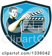 Clipart Of A Retro Male Movie Director Holding Up A Clapperboard In A Green White And Blue Shield Royalty Free Vector Illustration